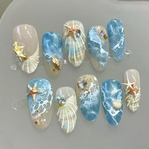 Blue seaside false nails, decorated false nails, seashell nail art, starfish nails, ocean-inspired nails, coastal nail designs, beach themed nails, Australian nail art