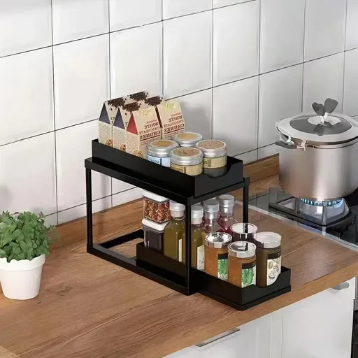 BLACK Two-tier pull-out storage rack. An organizational lifesaver for under the kitchen sink. Features adjustable shelves for easy storage of bottles and jars. In a sleek, modern design. Perfect as a kitchen shelf, bathroom organizer, or household st