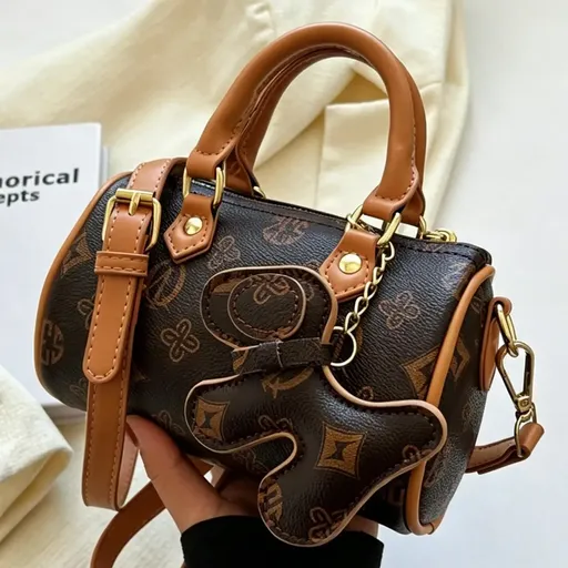 Classic Monogram Pillow Bag: Premium PU Leather with Luxe Feel, Cute Pet Charm for a Playful Touch, Compact Size Fits Phone, Multiple Carry Ways, Versatile for Commute & Dates./BROWN