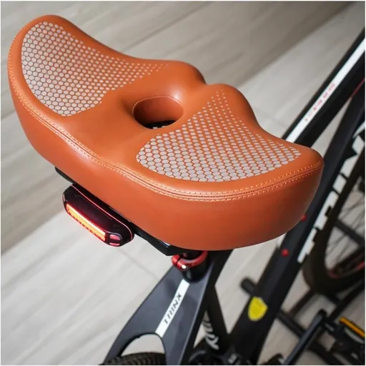 Noseless Bike Seat Wide,Padded Bike Seat for Men and Women,Bike Accessories Memory Foam Padding Dual Shock Balls and Center Vent for Mountain Bike Exercise Bike Electric Bike(Orange)