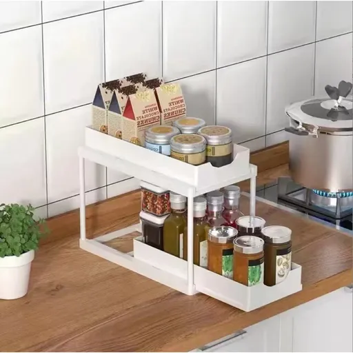Two-tier pull-out storage rack. An organizational lifesaver for under the kitchen sink. Features adjustable shelves for easy storage of bottles and jars. In a sleek, modern design. Perfect as a kitchen shelf, bathroom organizer, or household storage(